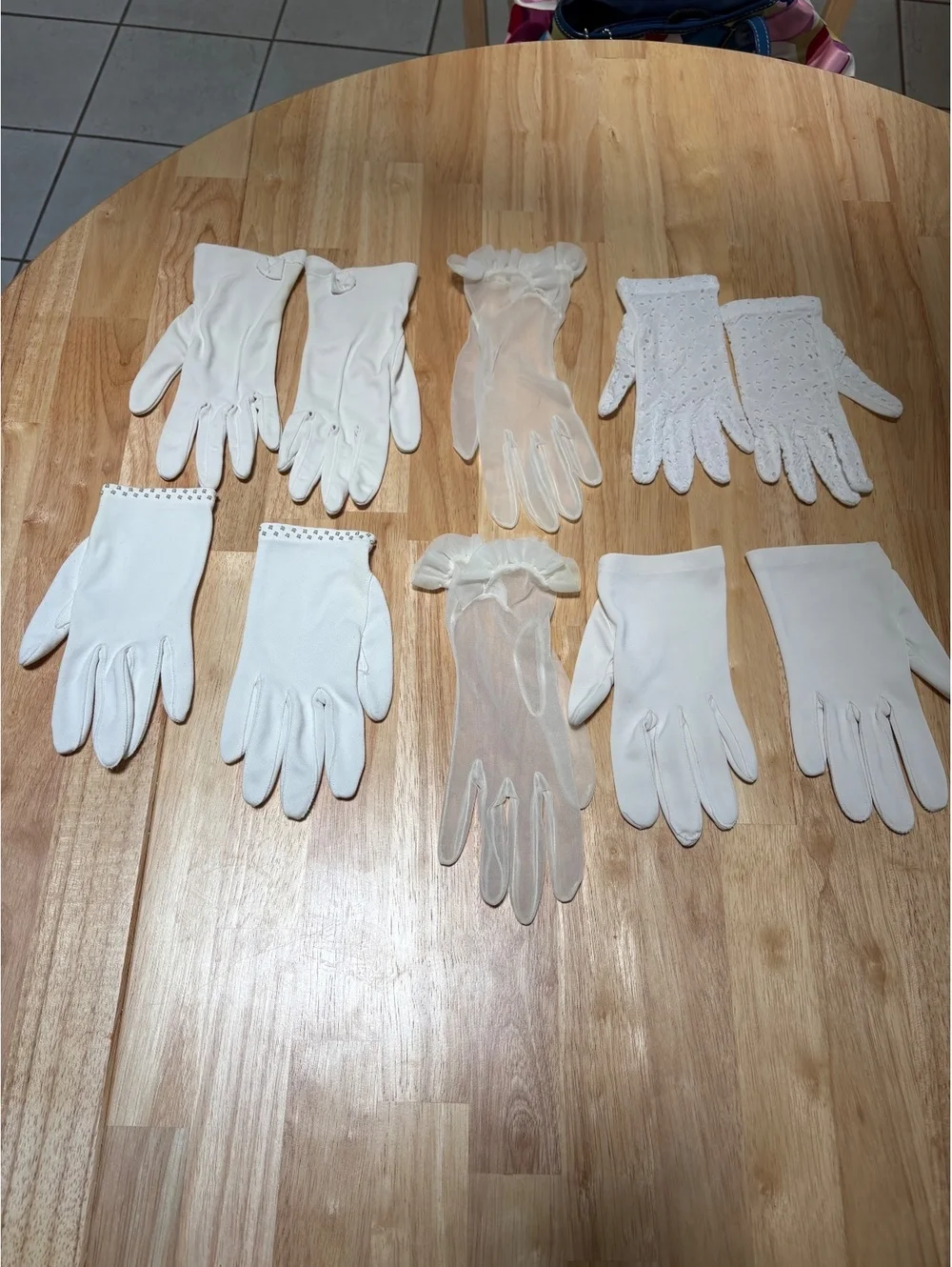 Five pairs of dress gloves. One pair of opera length gloves. Small size.